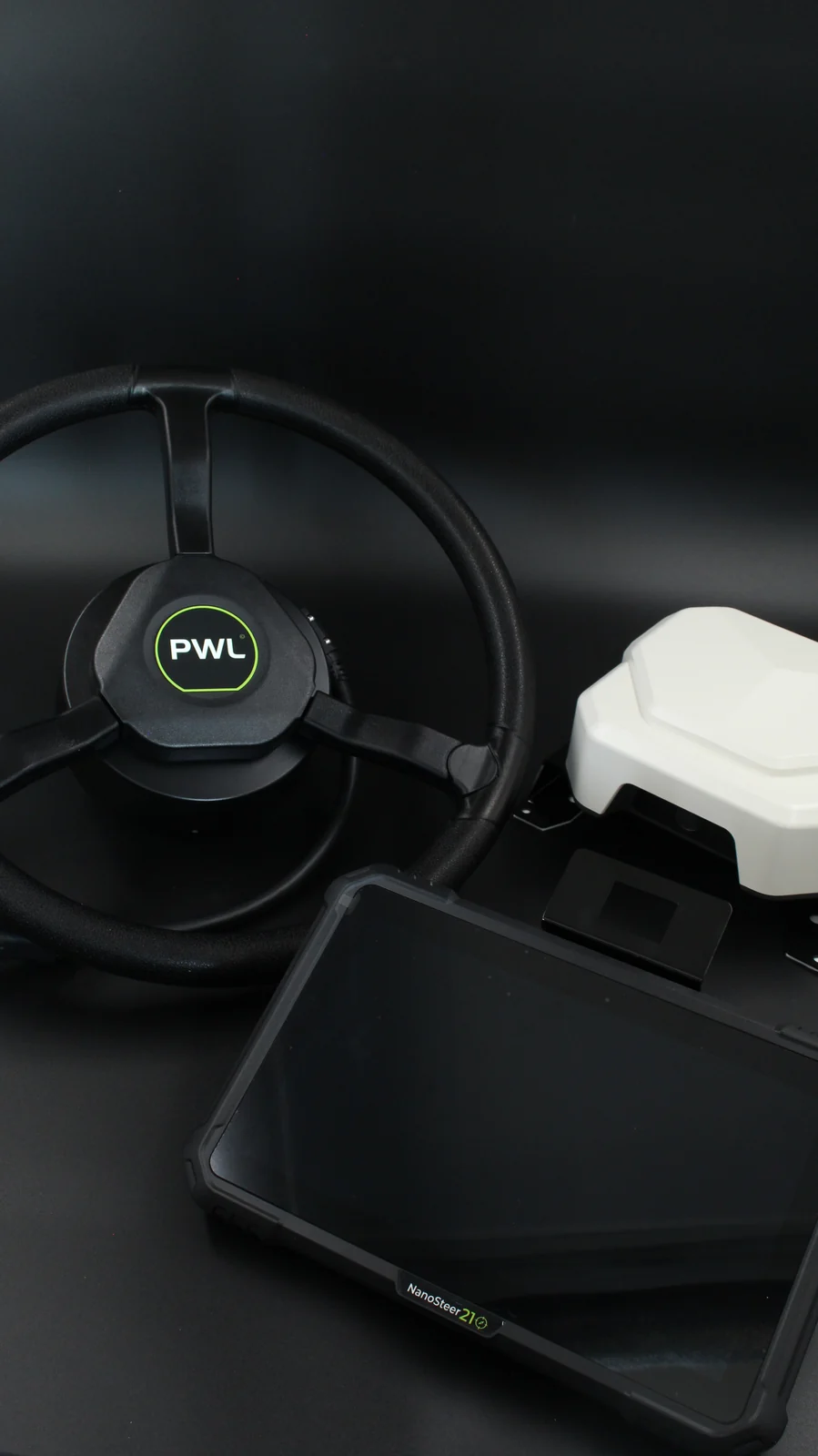 Manufacturer photograph of the NanoSteer terminal, steering wheel and GNSS receiver