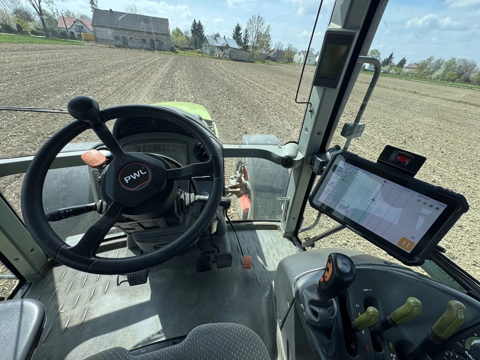 NanoSteer 210 terminal and motorised steering wheel installed in a tractor